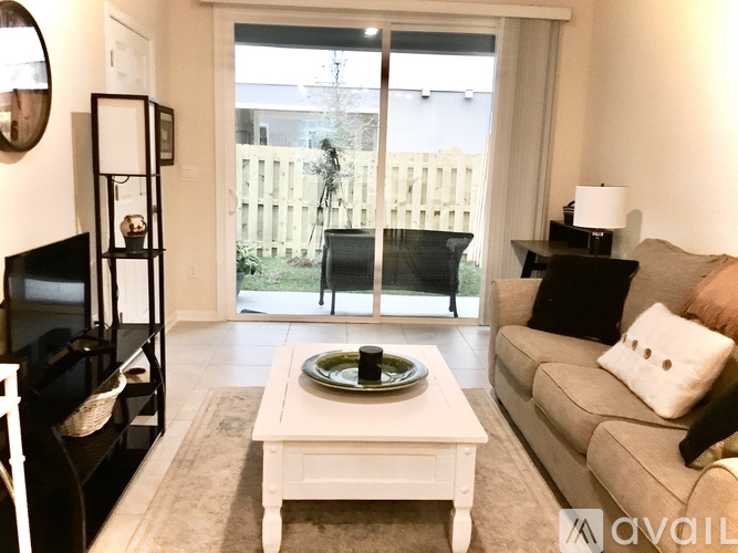 A living room with a white coffee table and a grey couch.