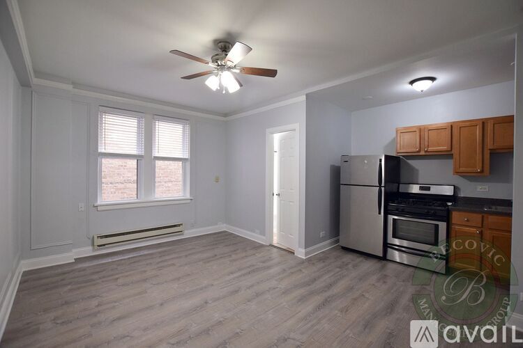 A kitchen with a refrigerator, oven, and microwave.