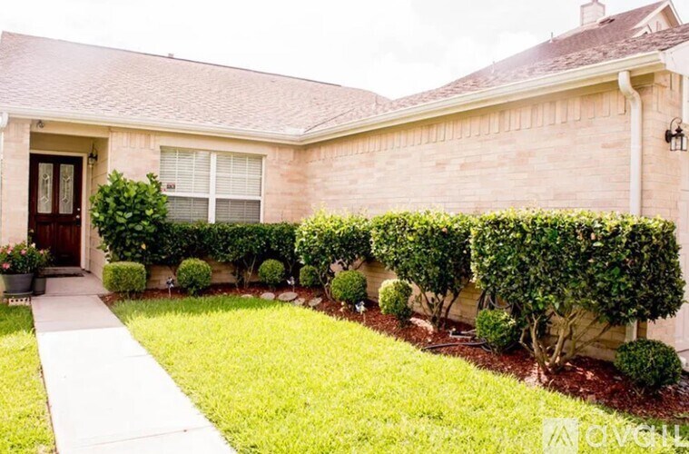 A house with a brown door and a small front yard.