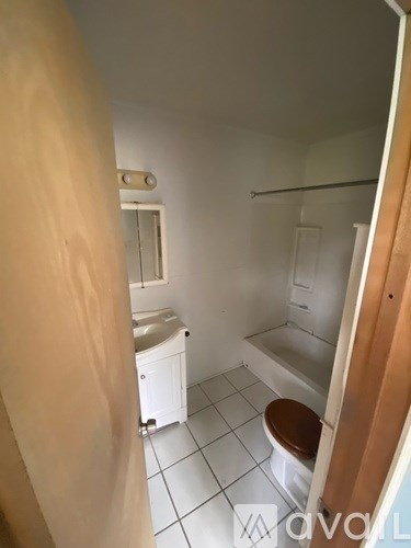 A bathroom with a toilet, sink, and bathtub.