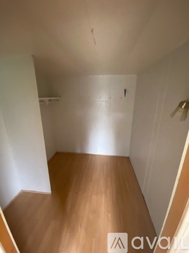 A room with wooden floors and white walls.