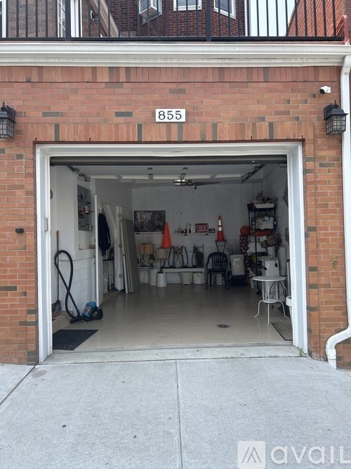 A garage with the number 855 on the wall above it.