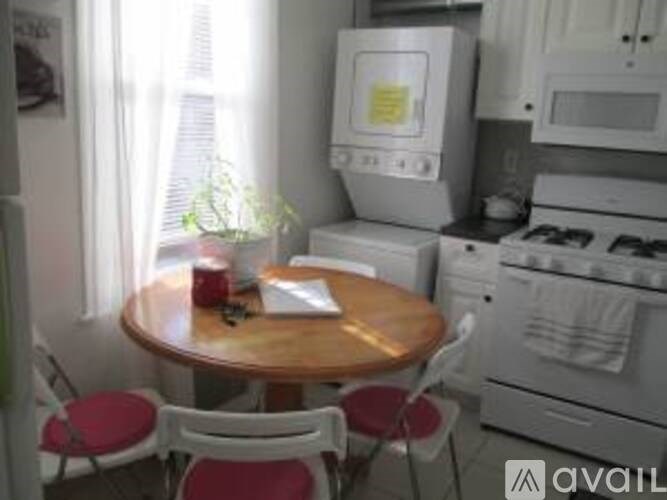 A small kitchen with a table and chairs.