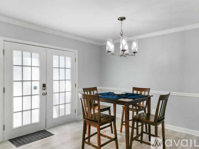 A dining room with a table set for four.