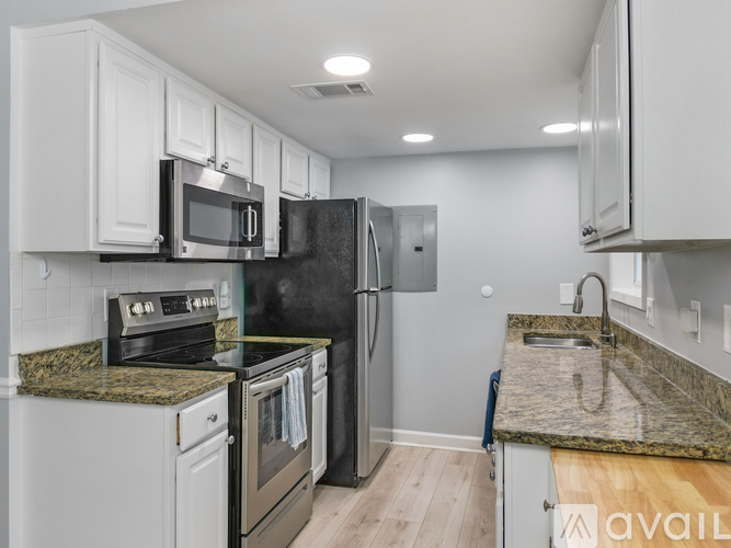 A kitchen with granite countertops and stainless steel appliances.