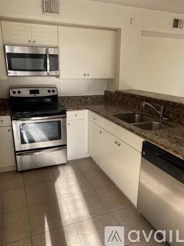 A kitchen with a stove top oven and microwave.