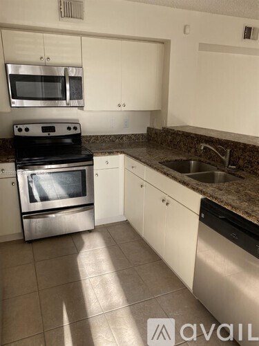 A kitchen with a stove top oven and microwave.