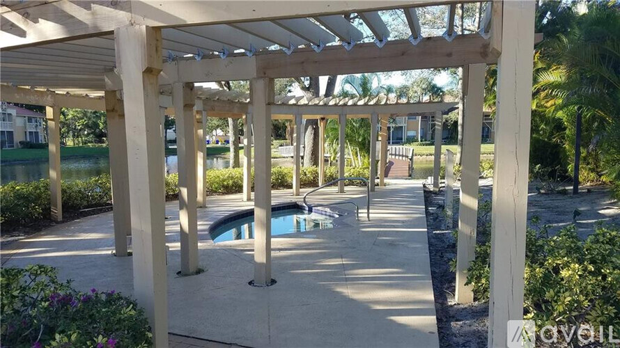 A pool area with a pergola and a pool table.