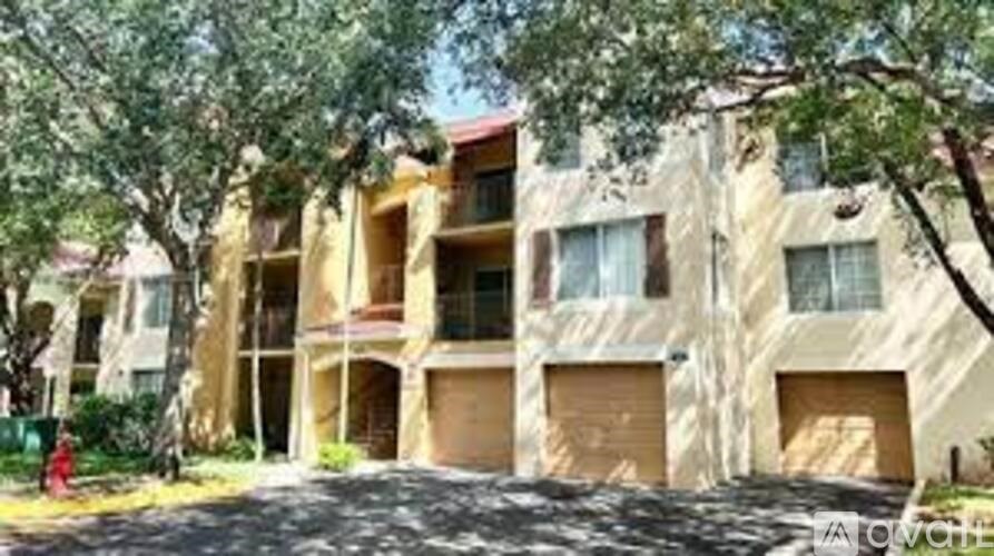 A building with a red roof and a tree in front of it.