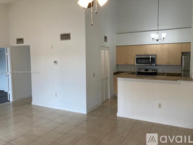 A kitchen area with a counter and cabinets.