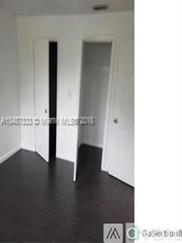 A room with white walls and a black floor.