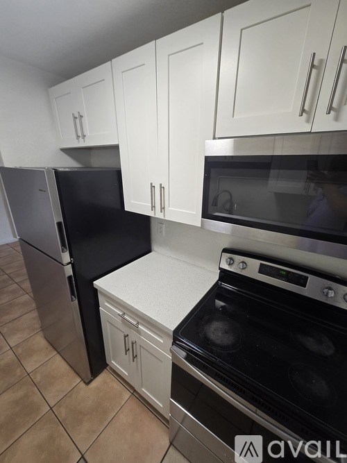 A room with a dark floor and white walls.