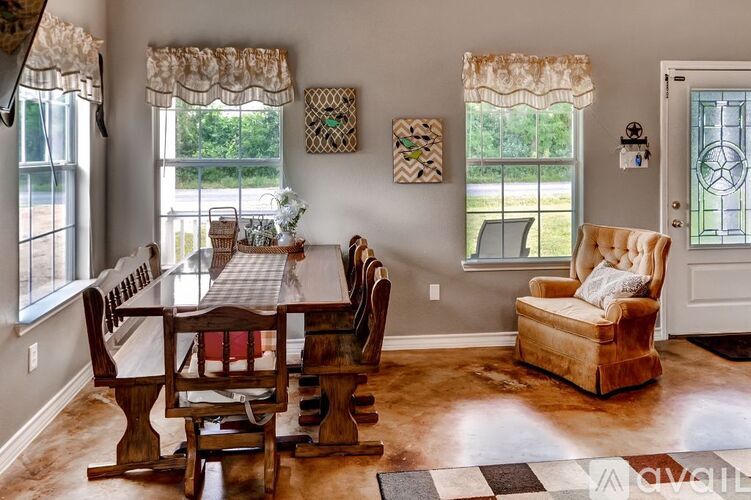A dining room with a wooden table and chairs.