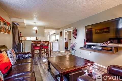 A living room with a brown leather couch and a wooden coffee table.