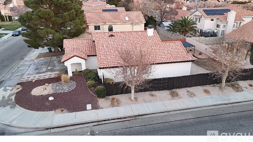 A house with a red tiled roof is available for sale.