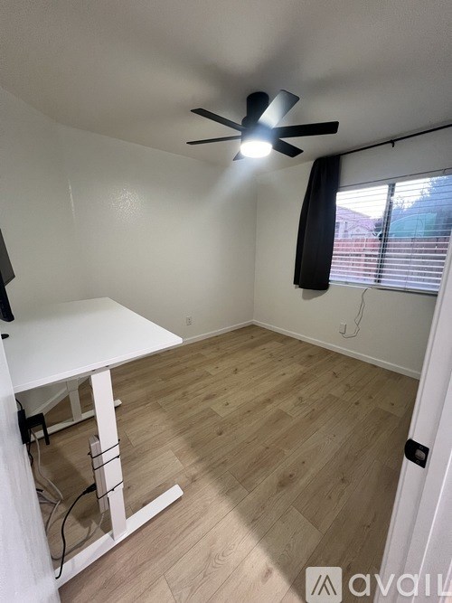 A gym with a squat rack, bench, and mats.