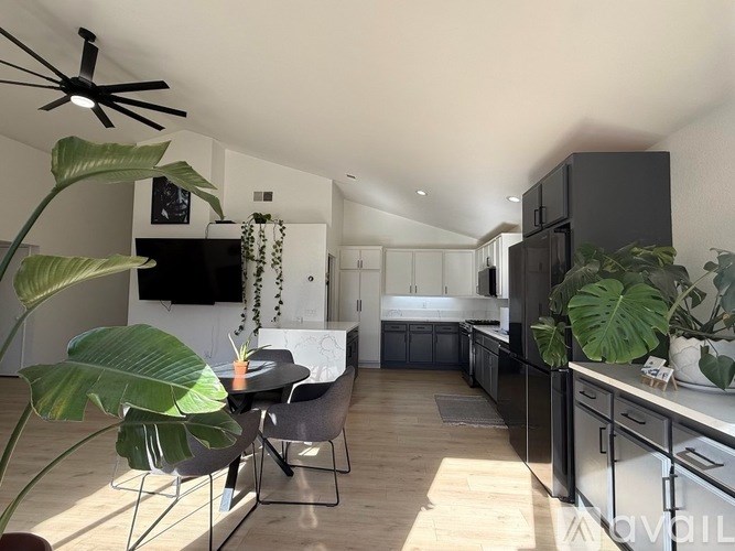 A modern kitchen with a dining table and chairs.