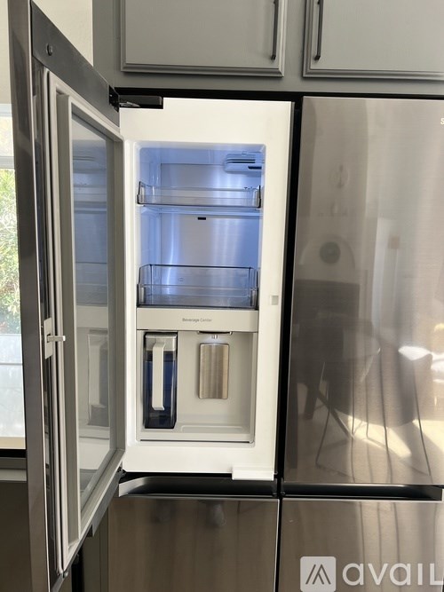 A bathroom with a sink, mirror, toilet and glass shower door.