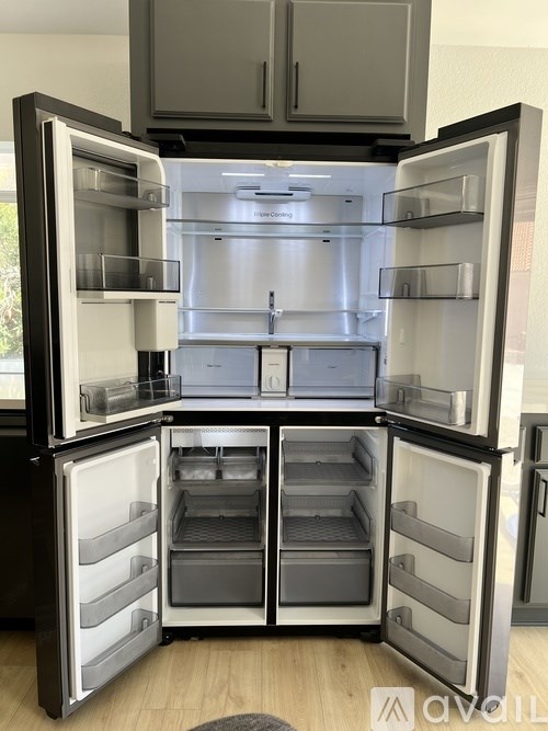A bedroom with a bed, a ceiling fan, and a window.