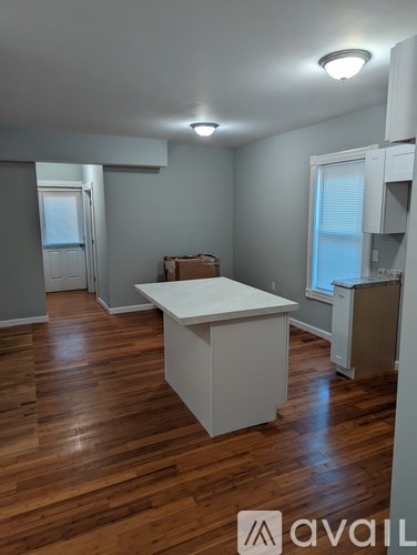 A room with wooden floors and a white table.
