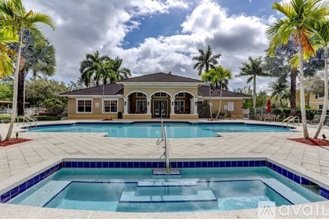 A house with a pool in front of it.