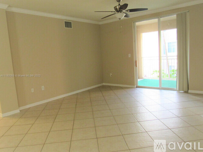 A room with beige walls and a ceiling fan.