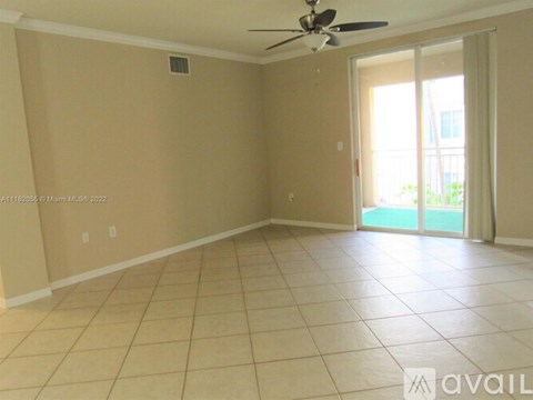 A room with beige walls and a ceiling fan.
