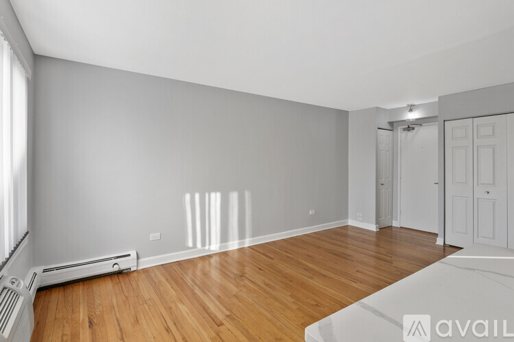 A room with wooden floors and white walls.