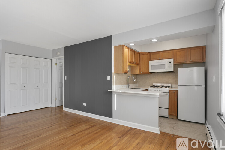 A kitchen with wooden cabinets and a white refrigerator.