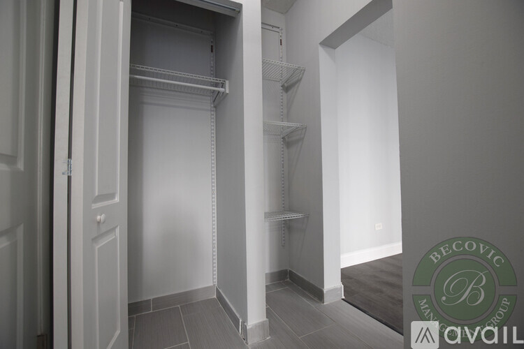 A white interior space with a doorway leading to a hallway.