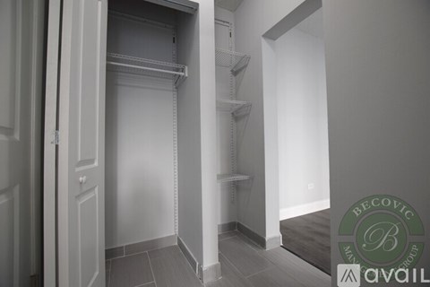 A white interior space with a doorway leading to a hallway.