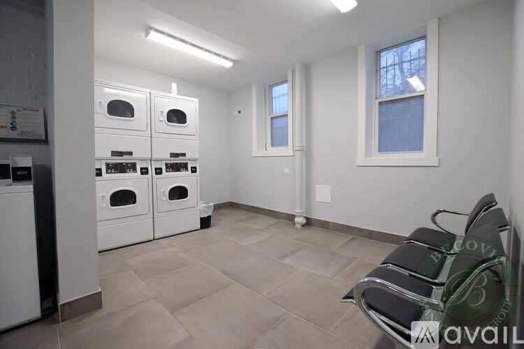 A kitchen with white appliances and a tile floor.