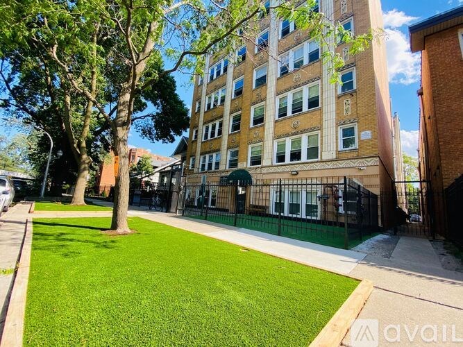 A building with a green lawn in front of it.