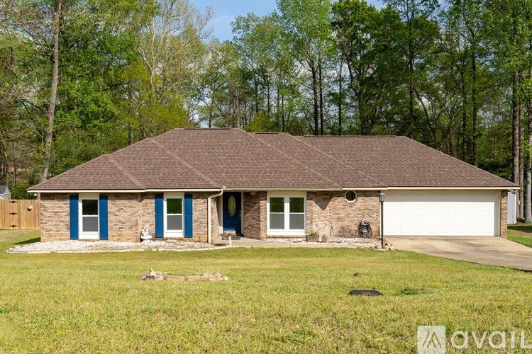 A house with a brown roof and blue windows is for sale.