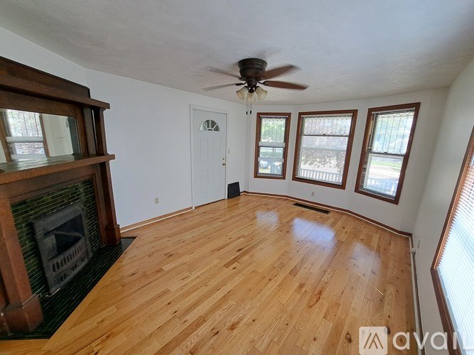 A room with wooden floors and a fireplace.