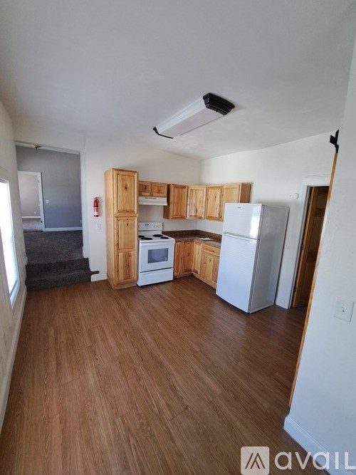A kitchen with wooden cabinets and white appliances.