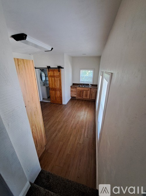 A room with wooden floors and a sliding door.
