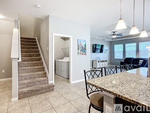 A living room with a dining table and chairs.