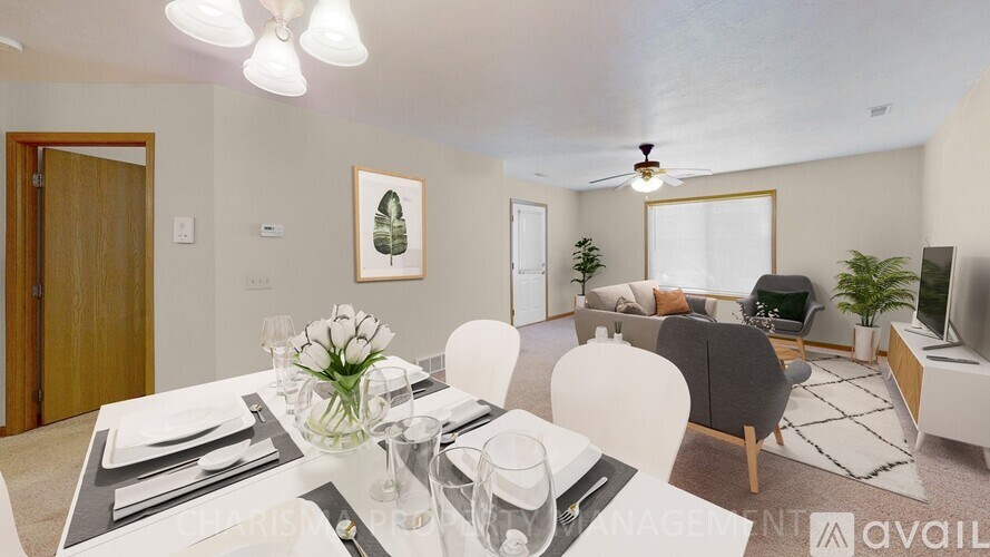 A dining room with a table set for a meal.