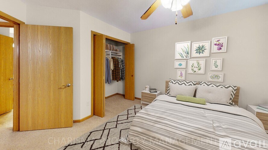 A bedroom with a large bed and a ceiling fan.