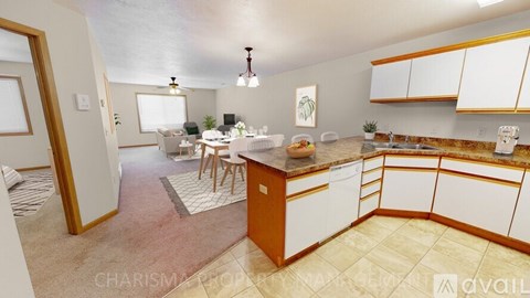 A kitchen with white cabinets and a wooden island.