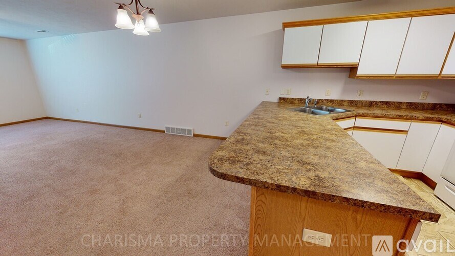 A room with a counter and cabinets is available for rent.
