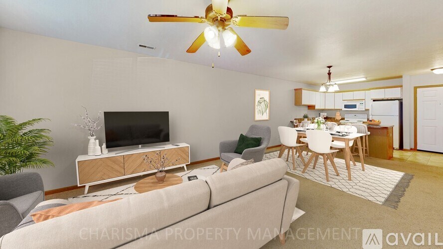 A living room with a television, a couch, and a dining table.