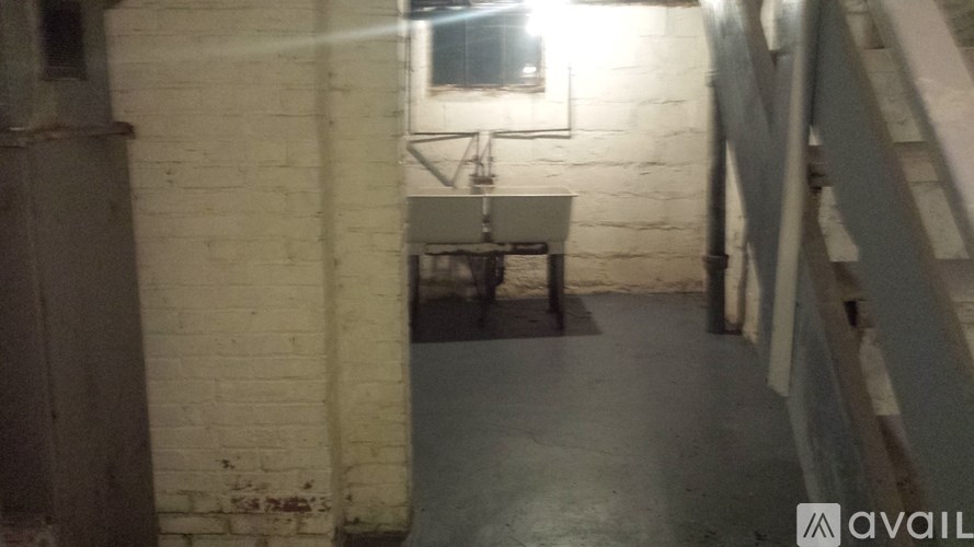 A dimly lit hallway with a bench and a window.