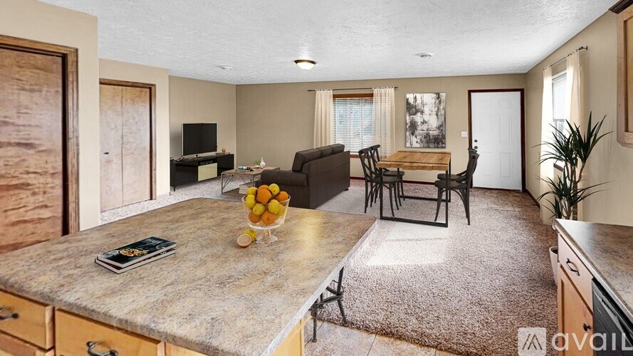 A kitchen with a table and chairs in the middle of the room.