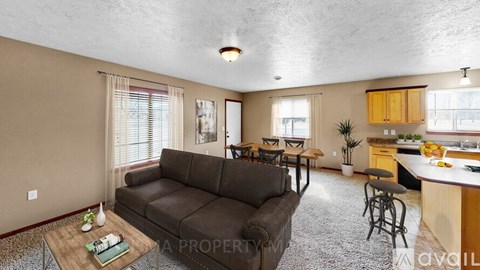 A living room with a brown couch and a coffee table.