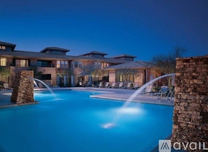 A large house with a pool in front of it.
