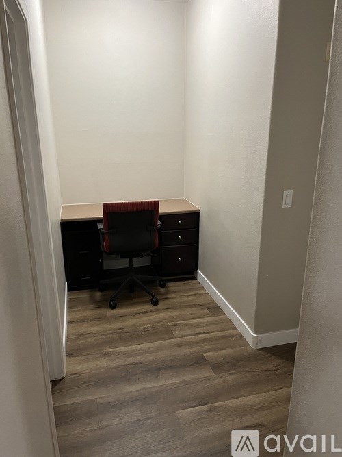 A room with a desk and a chair.