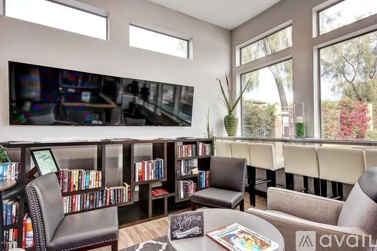 A living room with a bookshelf and a couch.
