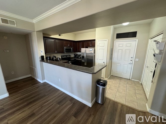 A kitchen with a white countertop and brown cabinets.